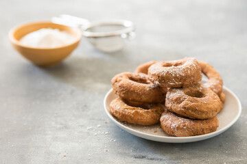 Homemade donuts sugar glazed on a stone background