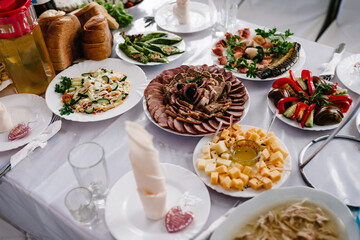 The holiday table cheese, meat, salads. Served table with food. Festive table. Table at restaurant before starting to celebrate.