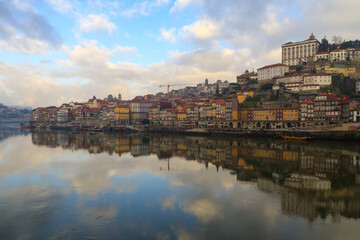 Fototapeta na wymiar Porto, Portugal panoramic cityscape on the Douro River at sunset. Urban landscape at sunset with traditional boats of Oporto city. Downtown and historic center, travel destination. Oporto landmark.