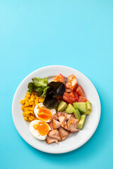salad salmon with vegetables and boiled egg on white plate