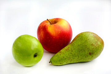 Red and green apples and green juicy pear on a white background