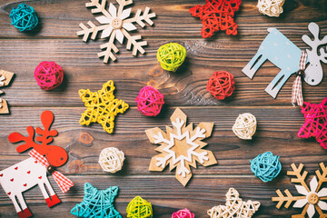 Top view of Christmas toys on wooden background. New Year ornament. Holiday concept