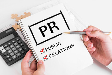 Businessman Writing PR Concepts on his Note