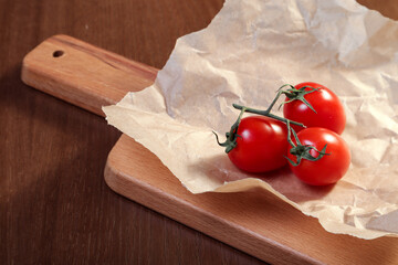 Cherry tomatoes on a wooden board. European cuisine.