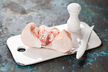 Raw lamb tail fat on a cutting board, selective focus