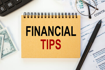 Business concept - notebook writing FINANCIAL TIPS