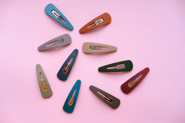 Colored hairpins on a pink background. High quality photo