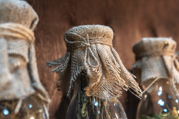 Glass bottles with dry herbs. Storage of natural medicines according to the old method. Close-up