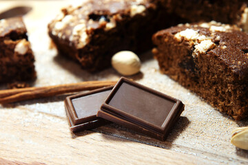 Pieces of dark chocolate on a background of biscuit. Ingredient for baking. Close-up