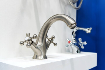 Silver tap on the counter in the store. Sale of plumbing in a specialized store