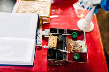 The sacrament of baptism. Attributes of an Orthodox priest for baptism. Baptism in the font. Child and God. Christening candle. Holy water.