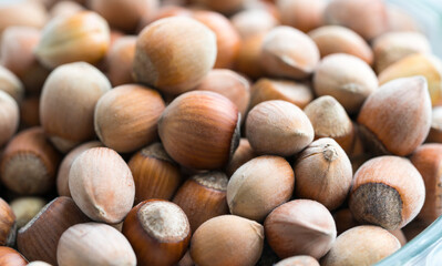 Healthy food for background image close up hazelnuts. Nuts texture on top view on the cup plate.