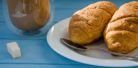 still life of cake with cup of coffee highlighted by sunlight