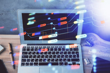 Double exposure of desktop computer and technology theme hologram. Concept of software development.