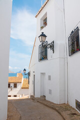 Beautiful typical street in Altea, Costa Blanca, Alicante province, Valencian Community, Spain. Historical center, with white charming houses. No tourist, dreamy atmosphere.