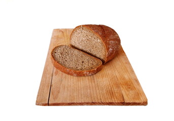 Freshly baked sliced bread on wooden cutting board isolated on white background. Fresh Bread. Hunger and poverty concept.