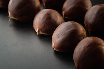 Rows of chestnuts isolated on black background