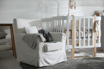Fototapeta na wymiar Baby room interior with crib and armchair. Idea for design