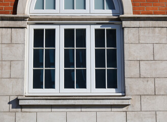 Fototapeta na wymiar Window of old English building set in traditional blocks and brickwork