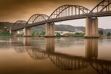 Fototapeta na wymiar Old iron and cement bridge, Marechal Carmona in Vila Franca de Xira
