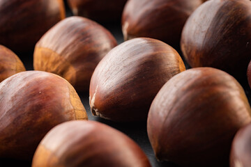 Rows of chestnuts isolated on black background