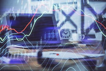 Forex market chart hologram and personal computer background. Double exposure. Concept of investment.