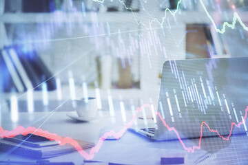 Stock market graph and table with computer background. Double exposure. Concept of financial analysis.