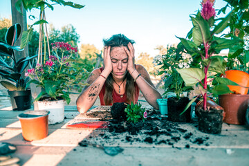 Disappointed latin young woman transplanting plants and flowers