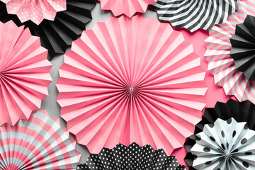 Fototapeta Vibrant background with black, pink and white folded paper fans on two tone background. obraz