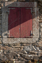 Red Shuttered Window in Rustic Old Stone House in Galicia, Spain