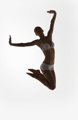 Fototapeta na wymiar silhouette of jumping ballet dancer