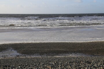 The deserted, stormy, wintry beach at Dyffryn Ardudwy, Wales, UK.