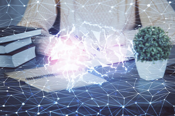 Multi exposure of writing hand on background with brain hologram. Concept of learning.