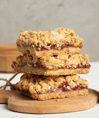 stack of baked crumble pie with fruit filling and sprinkled with grated almonds