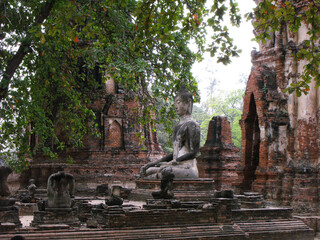 Ayutthaya, Thailand, January 24, 2013: Buddhas and brick stupas in the ruins of Ayutthaya, ancient capital of the kingdom of Siam. Thailand