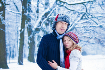 Fototapeta na wymiar Stylish beautiful couple in winter park on a nature background