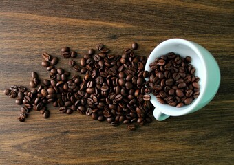 coffee beans in a coffee cup (mug) on a wooden table