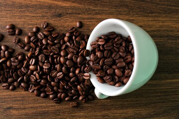 coffee beans in a cup on wooden background