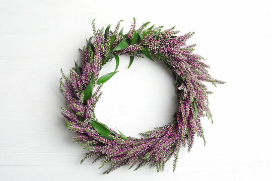 Beautiful autumnal wreath with heather flowers on white background, top view. Space for text
