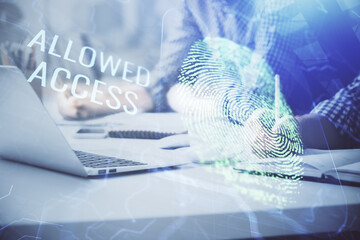 Fingerprint hologram with businessman working on computer on background. Security concept. Double exposure.