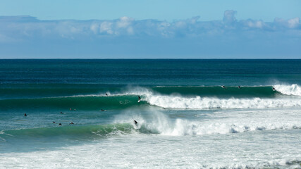 Surfers having fun riding waves on a sunny day