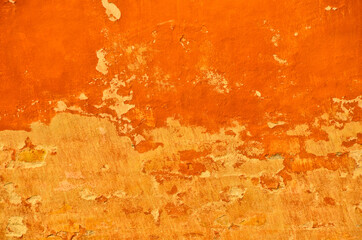 bright and vibrant orange coloured finery, plastering part of a wall, old and vintage, weathered