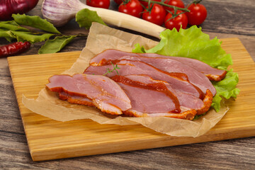 Sliced smoked duck breast served salad
