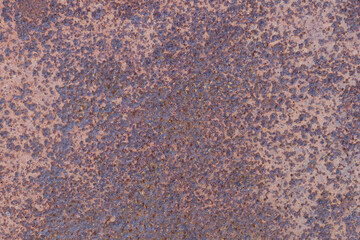 The texture of an old metal surface pitted with rust.