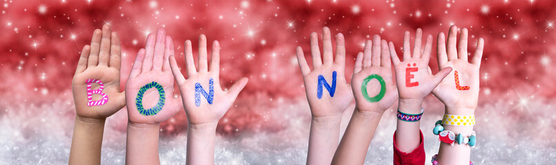 Children Hands Building Colorful French Word Bon Noel Means Merry Christmas. Red Snowy Christmas...