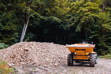 Yellow construction vehicle in forest
