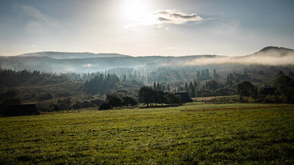 Obraz premium Autumn mountain village scenery. Clouds rising from Carpathian Mountains, Ukraine.
