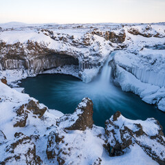 Aldeyjarfoss waterfall at sunset in winter. Columnar basalt formations around the fall. North Iceland.