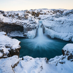 Fototapeta premium Aldeyjarfoss waterfall at sunset in winter. Columnar basalt formations around the fall. North Iceland.