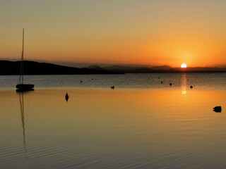 Sunset over the sea in the background island and boat.